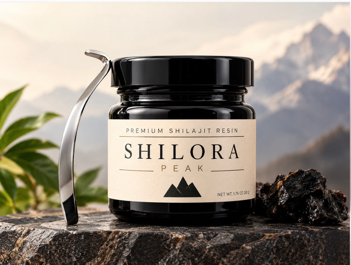 Shilora Peak Himalayan shilajit resin 50g jar with metal scoop spoon on a stone ledge with mountains behind